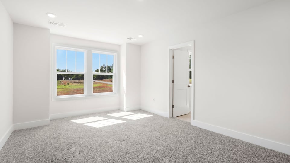 Bedroom with carpet and window.