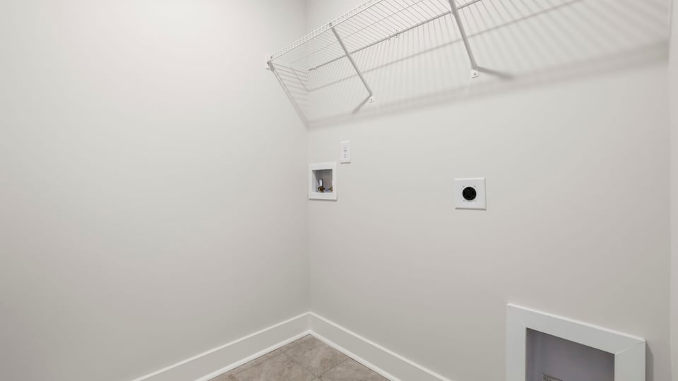 Laundry room with hanging storage racks.