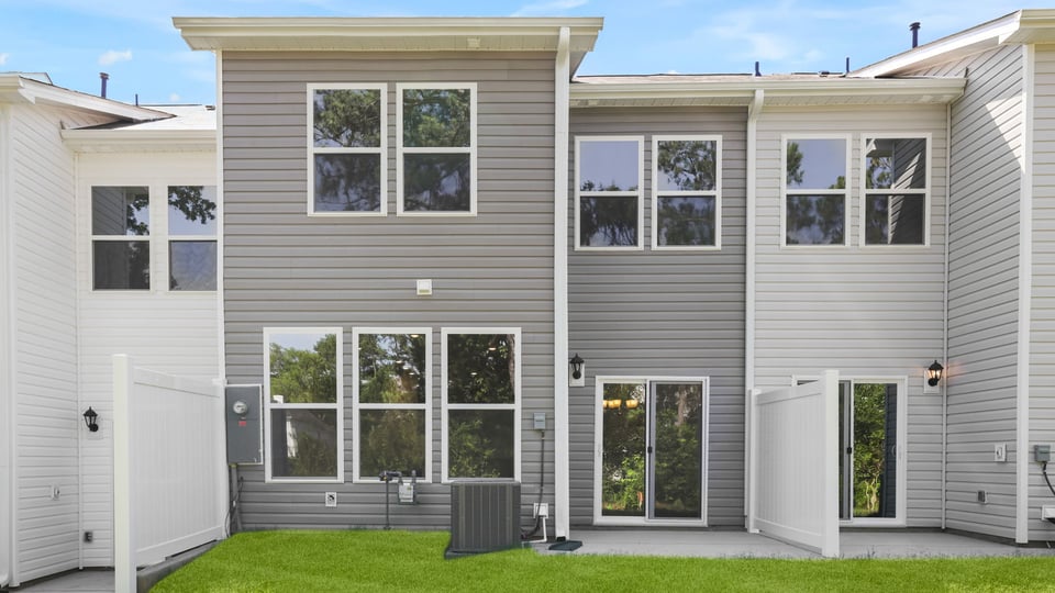 Back exterior of home with large backyard.
