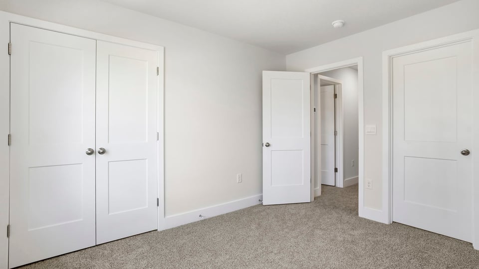 Bedroom with carpet and window.