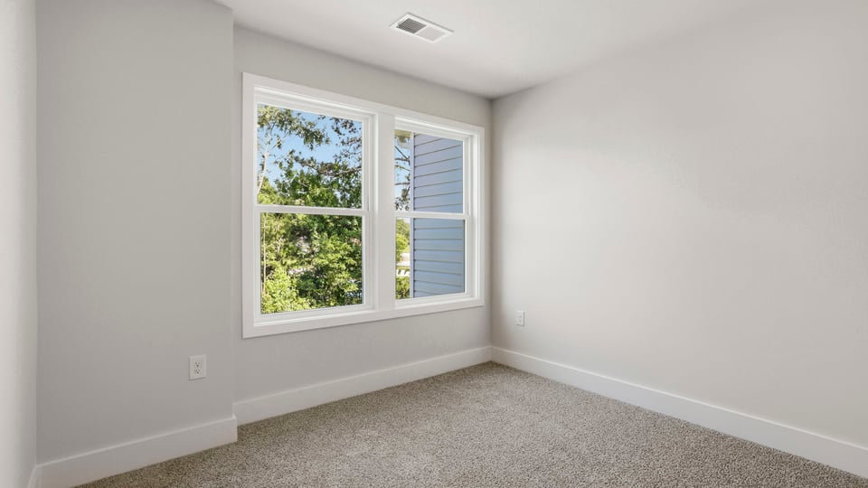 Bedroom with carpet and window.