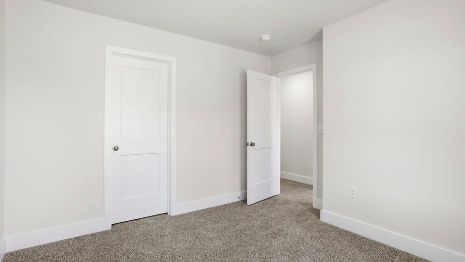 Bedroom with carpet and window.