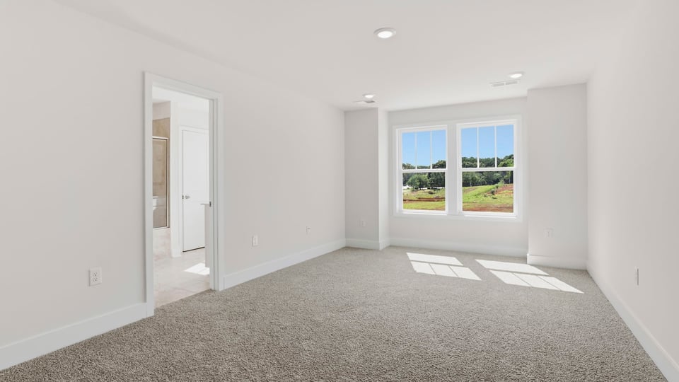 Bedroom with carpet and window.