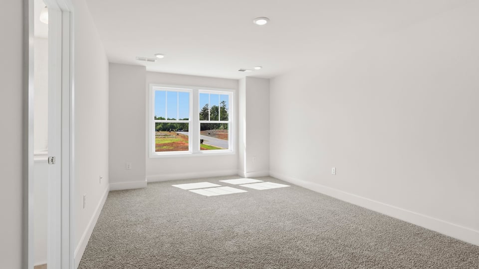 Bedroom with carpet and window.