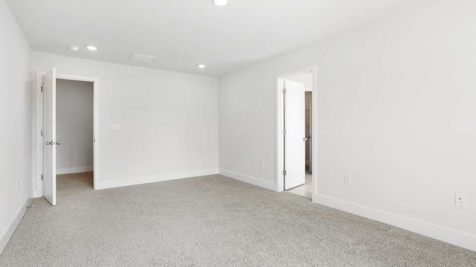 Bedroom with carpet and window.