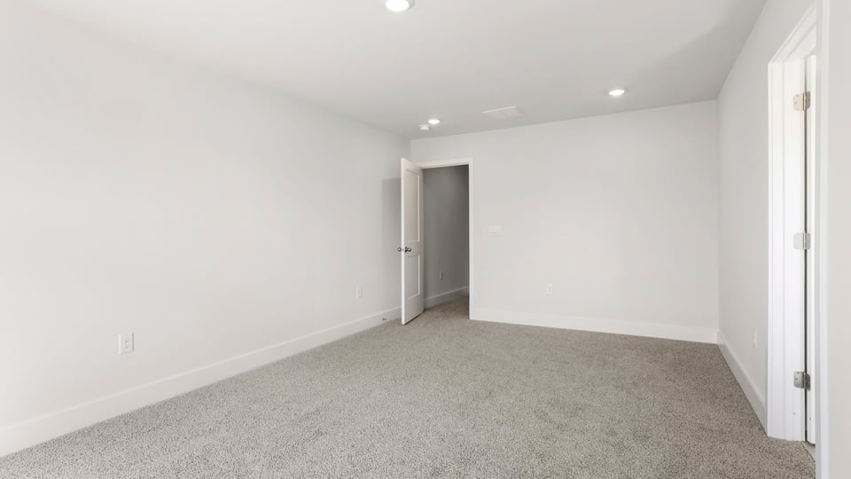 Bedroom with carpet and window.