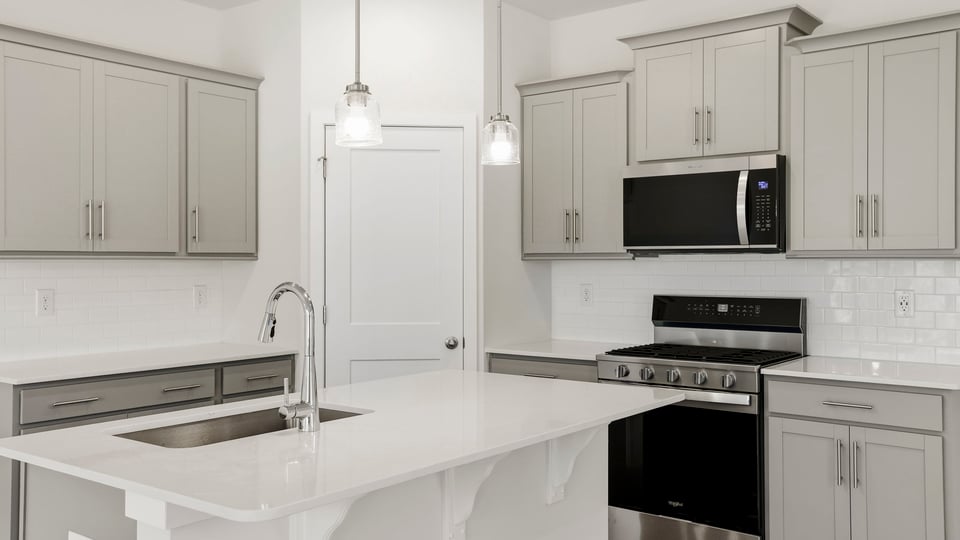 Kitchen and island with stainless steel appliances.