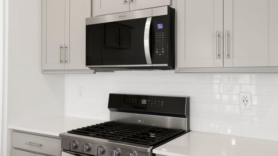Kitchen and island with stainless steel appliances.
