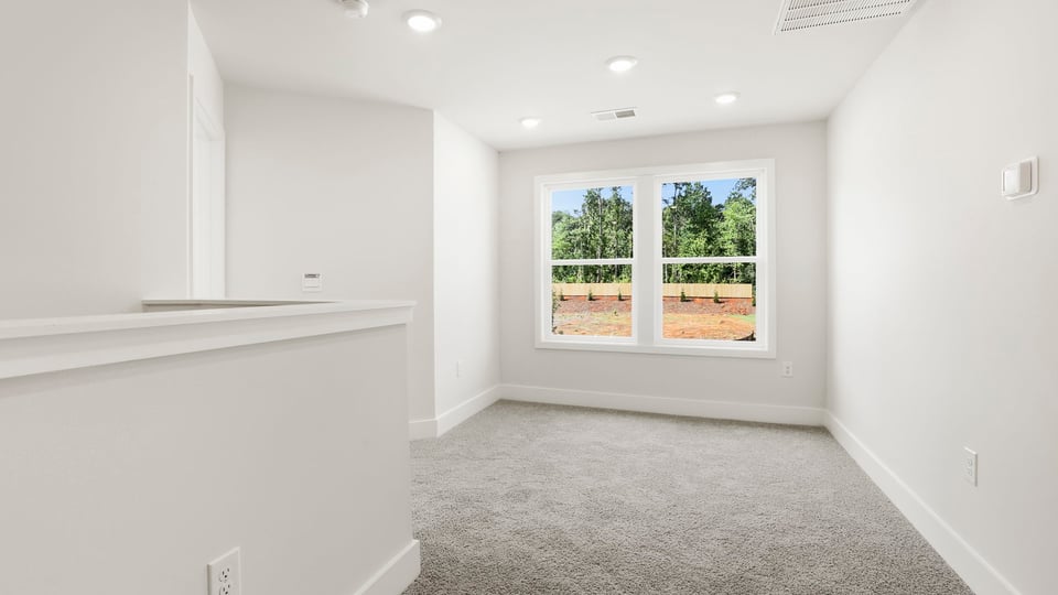Bedrooms with carpet and window.