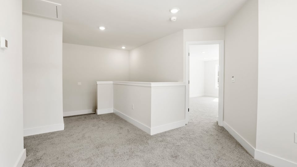 Loft area with carpet.