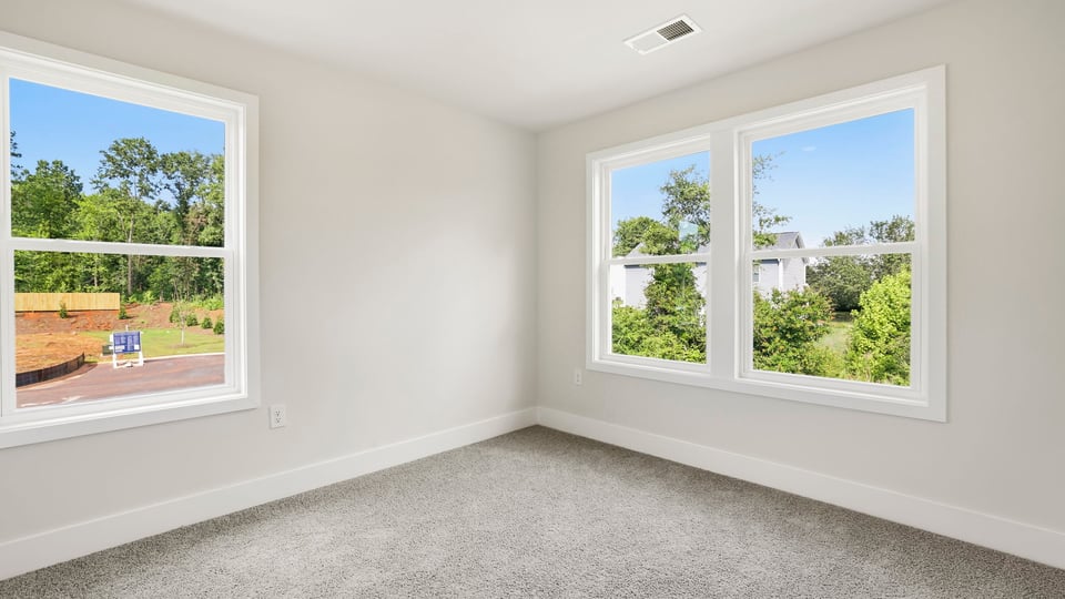 Bedroom with carpet and window.