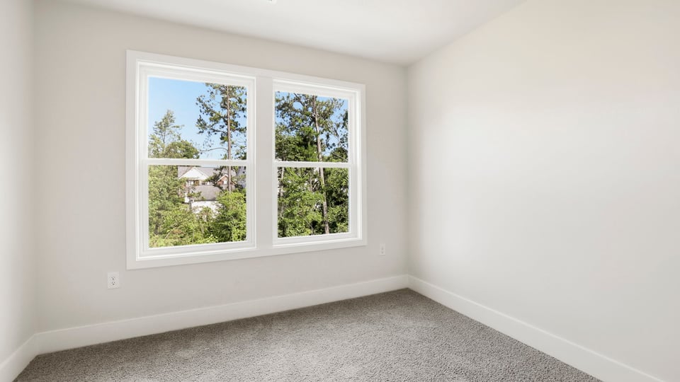Bedroom with carpet and window.