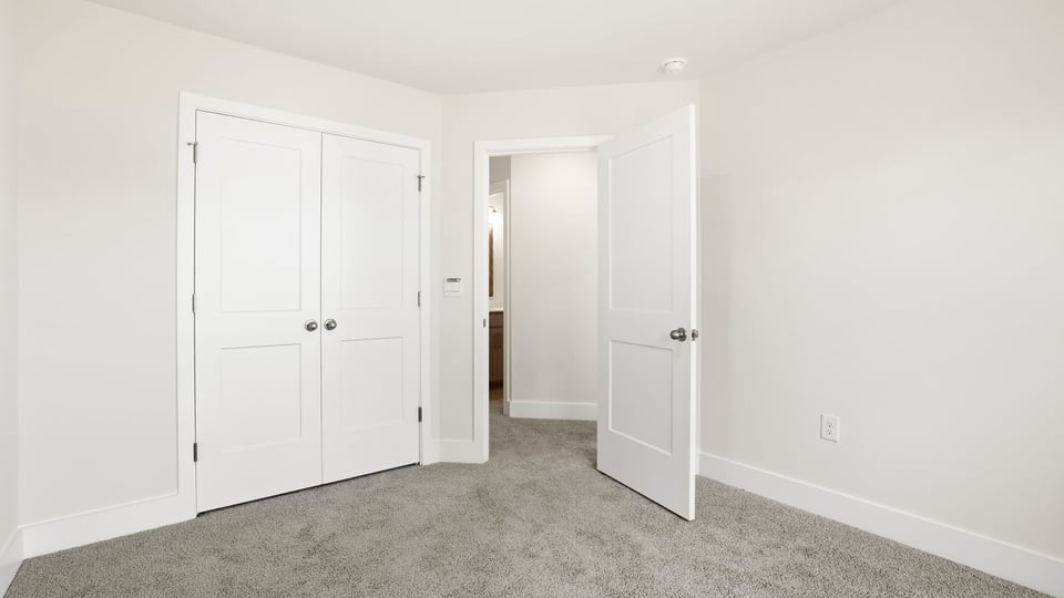Bedroom with carpet and window.