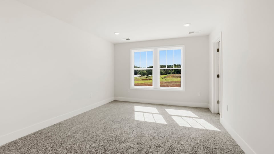 Bedroom with carpet and window.