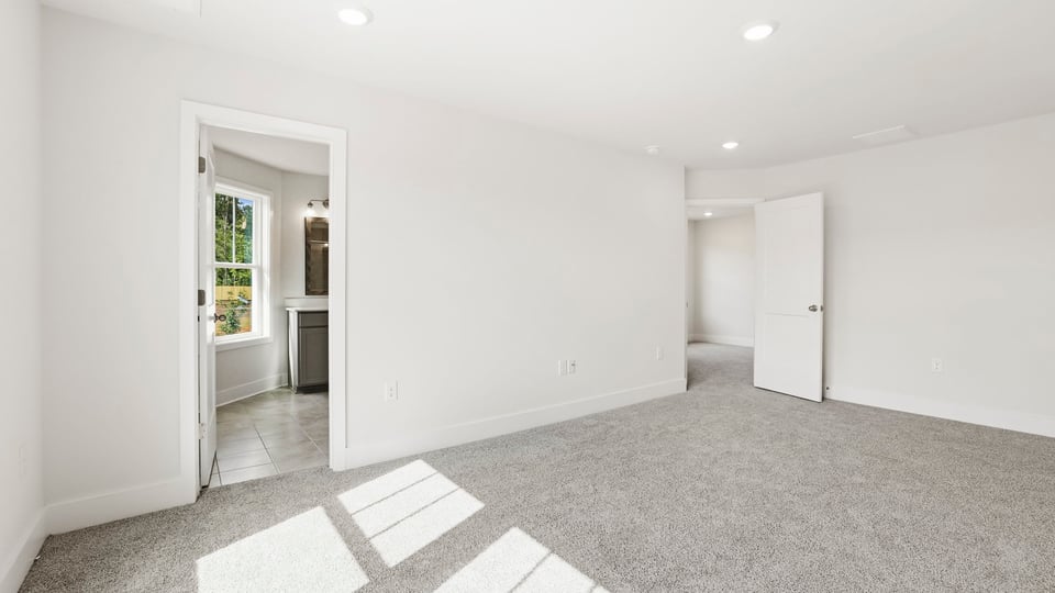 Bedroom with carpet and window.