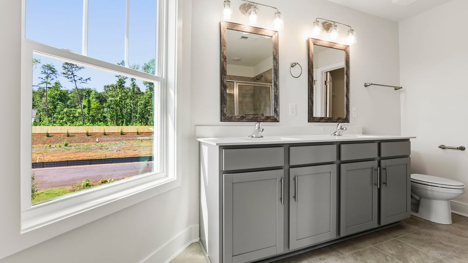 Bathroom with double vanity sink and window.