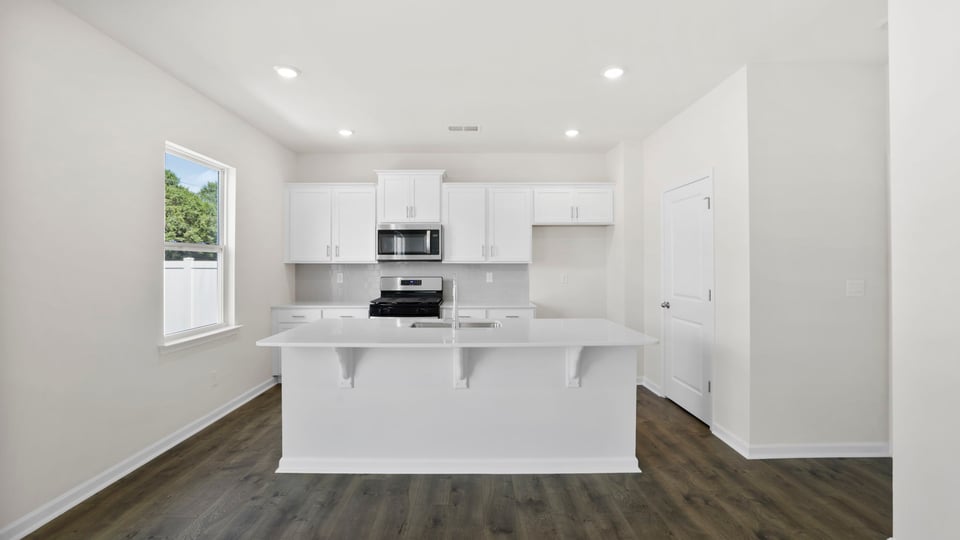 Kitchen with island and cabinets.