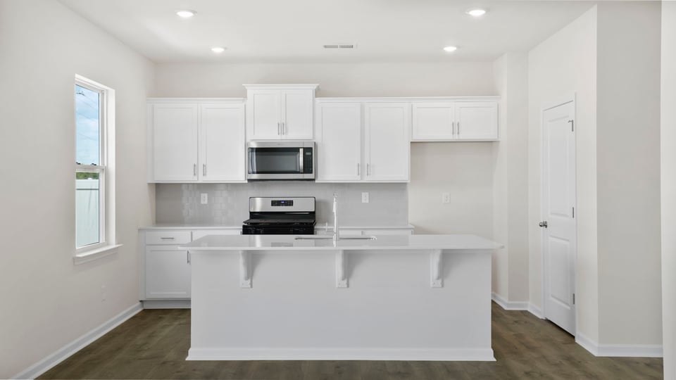Kitchen with island and cabinets.