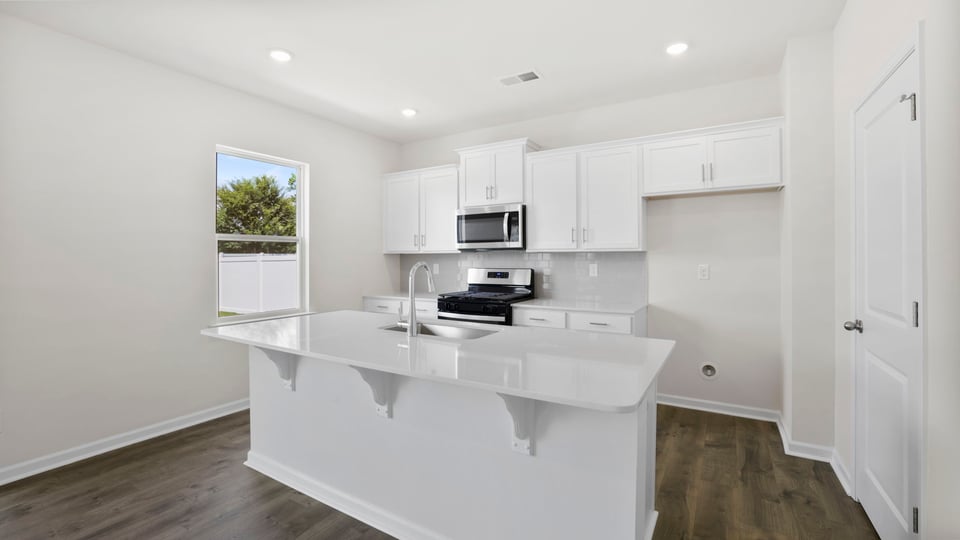 Kitchen with island and cabinets.