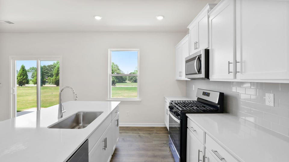 Kitchen with island and cabinets.