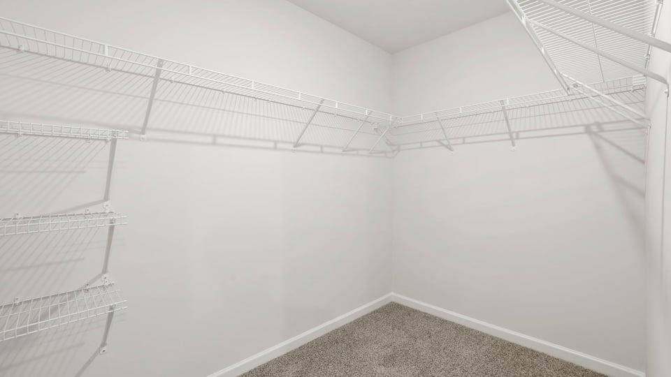 Primary closet with shelf.