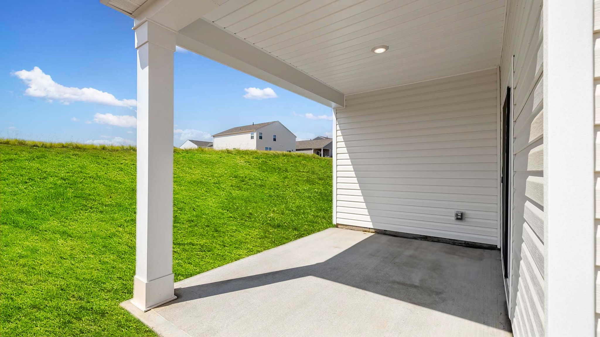 Back exterior of home with covered patio.