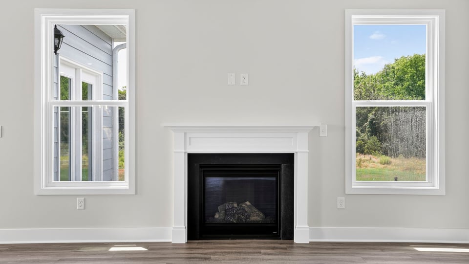 Living area with fireplace and windows.