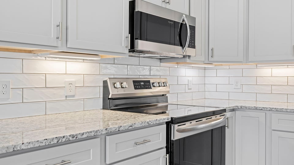 Kitchen with island and cabinets.