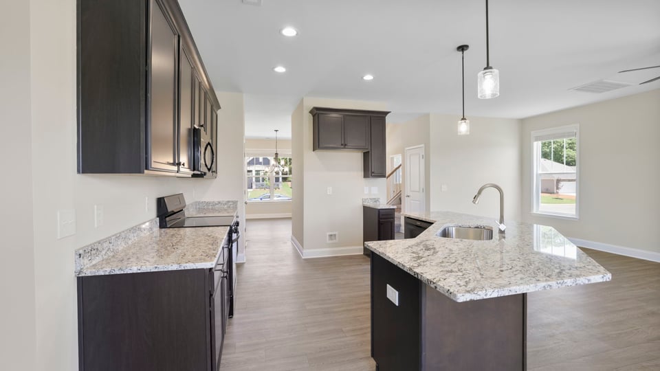 Kitchen and island with stainless steel appliances.