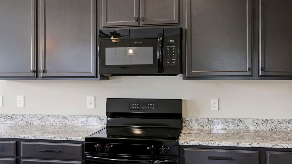 Kitchen and island with stainless steel appliances.