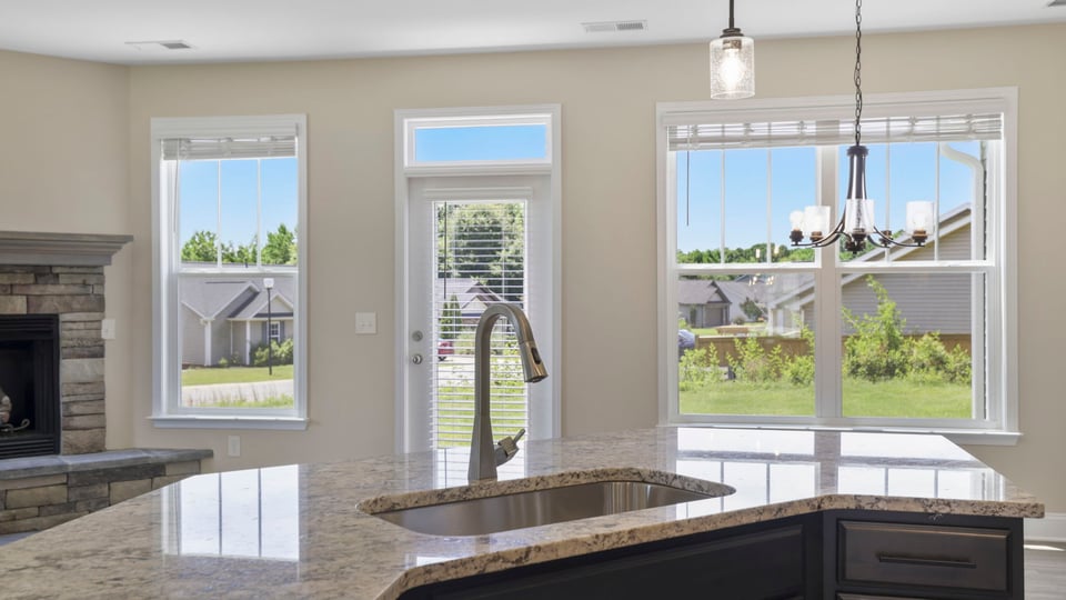 Kitchen and island with stainless steel appliances.