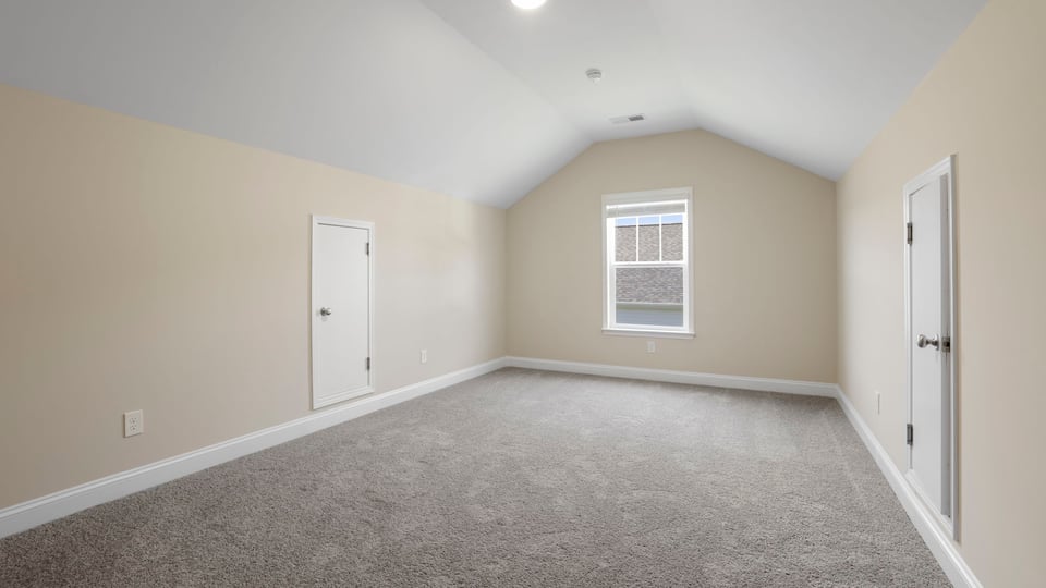 Bedroom with carpet and window.