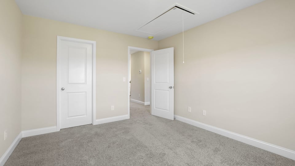 Bedroom with carpet and window.