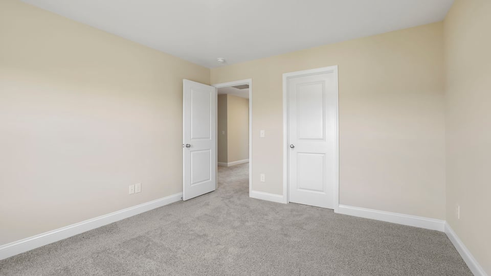 Bedroom with carpet and window.
