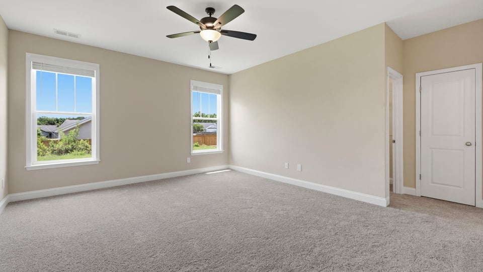 Bedroom with carpet and window.