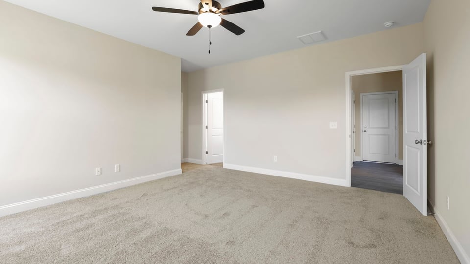Bedroom with carpet and window.