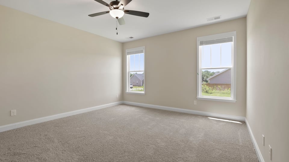 Bedroom with carpet and window.