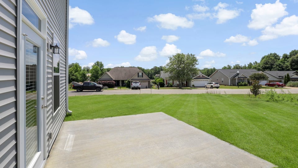 Back exterior of home with patio.