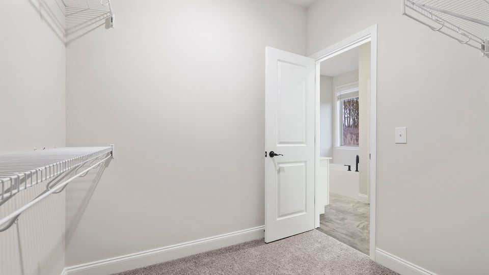 Primary bedroom walk-in closet.