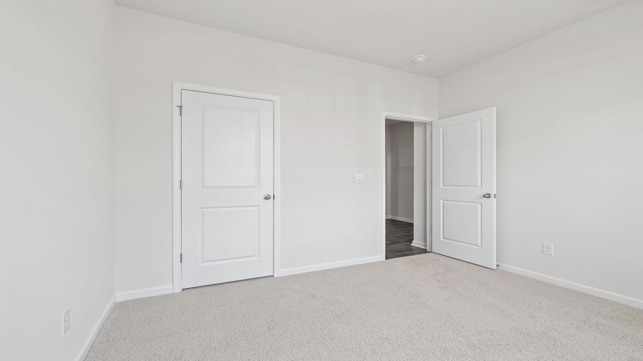 Bedroom with windows and carpet.