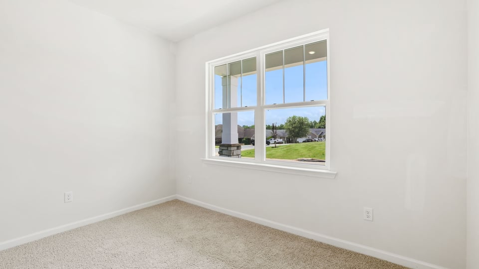 Bedroom with carpet and window.