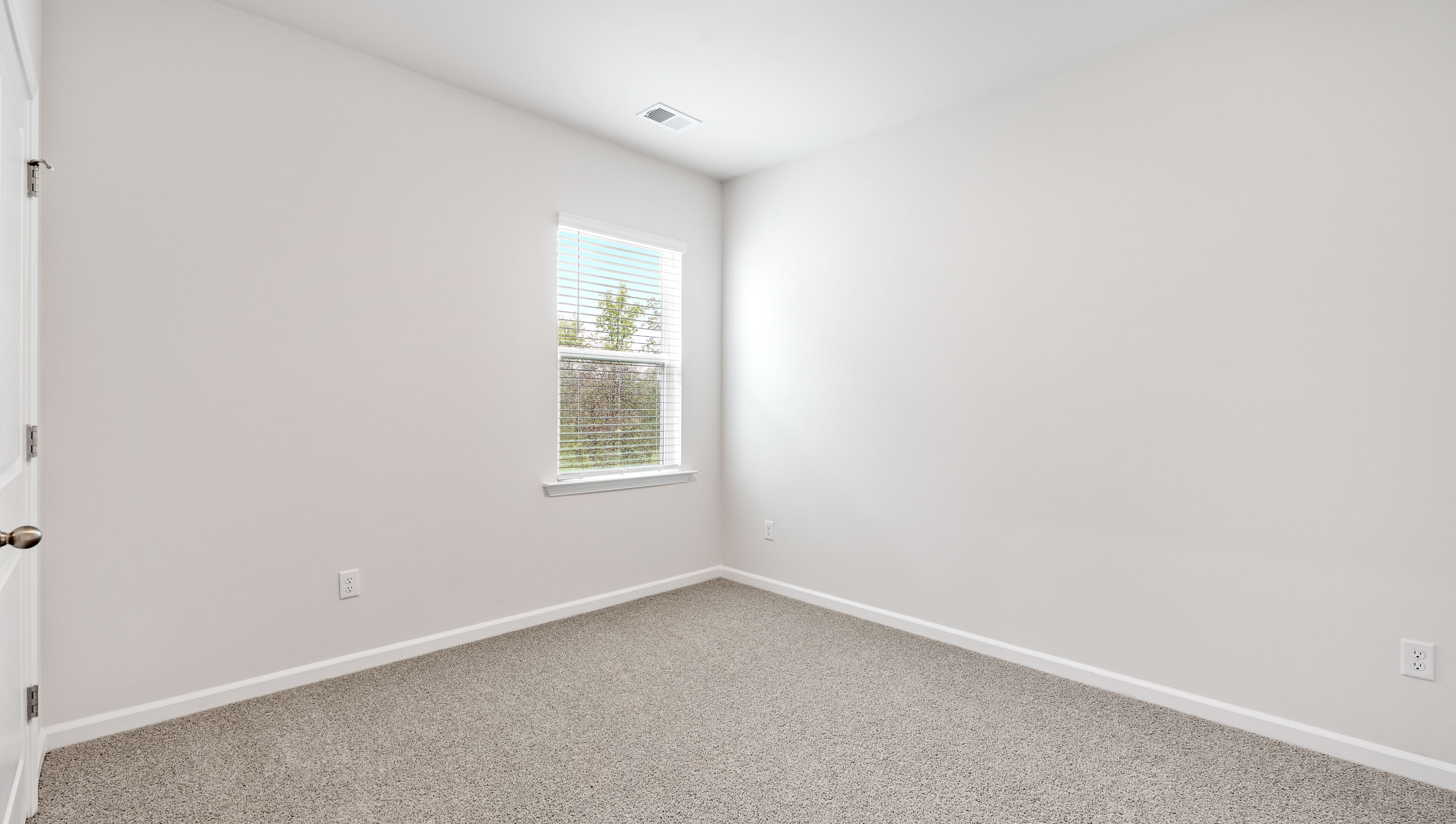 Bedroom with carpet and windows.