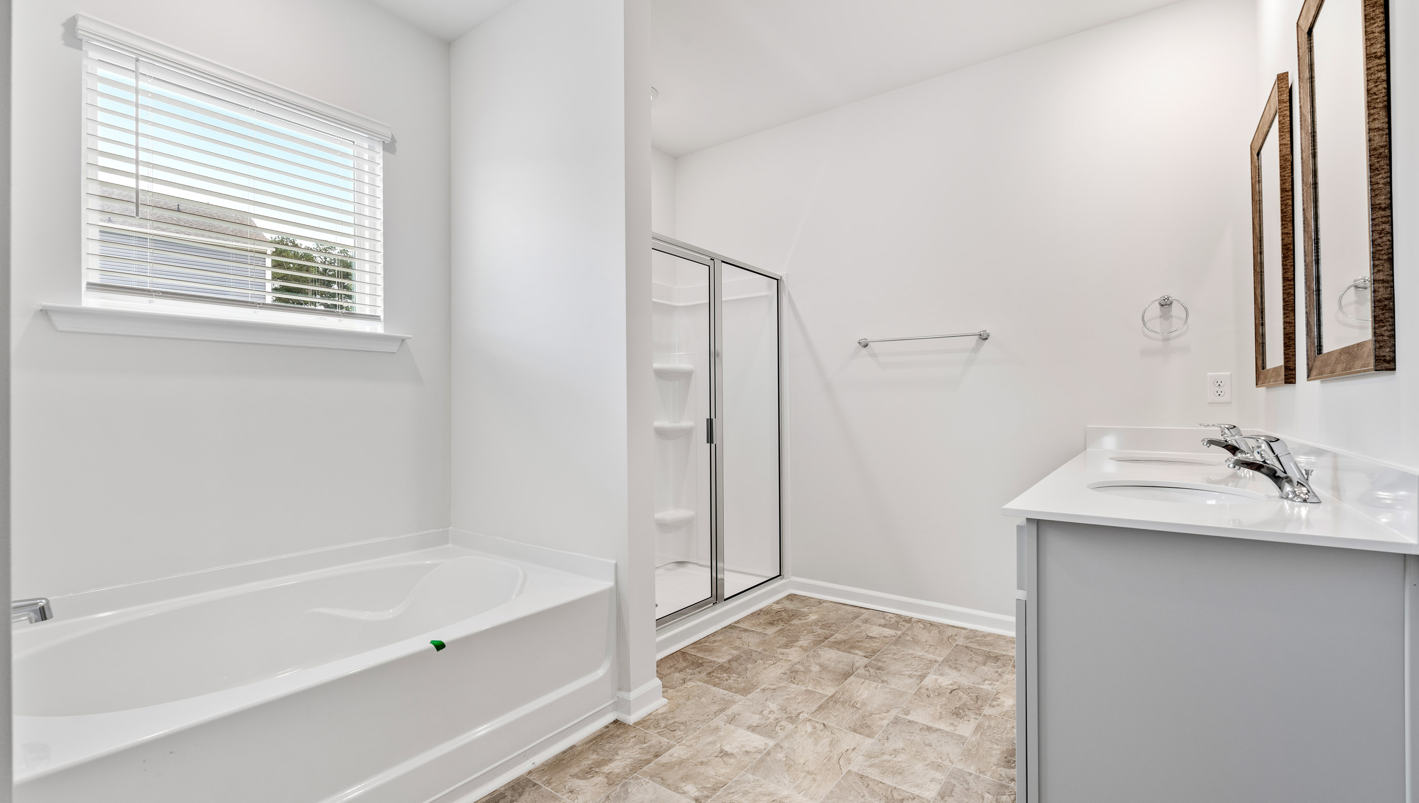 Primary bathroom with dual sink vanity and walk-in shower.