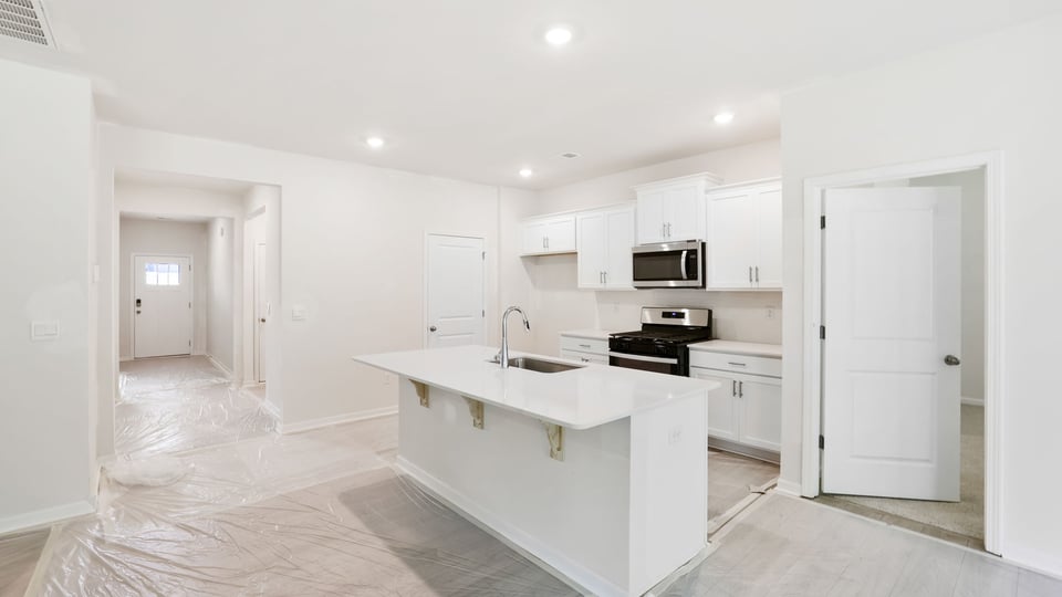 Kitchen and island with quartz countertops.