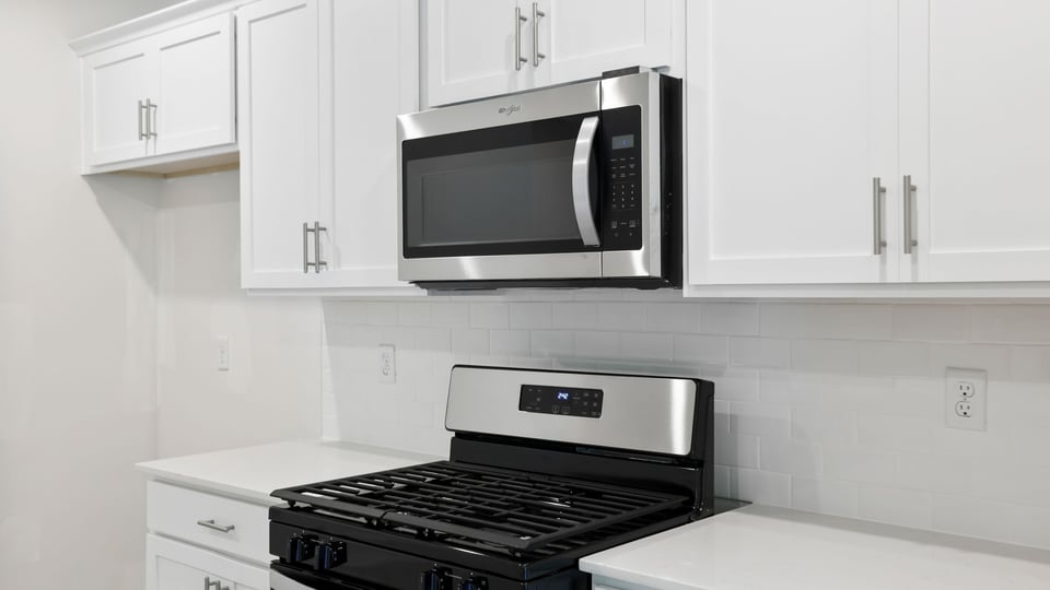 Kitchen and island with quartz countertops.