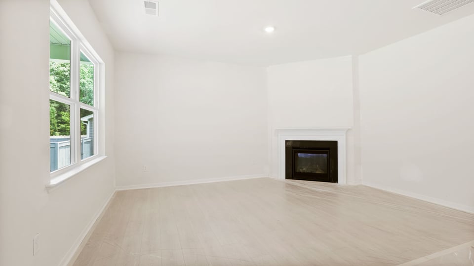 Family room with fireplace and window.