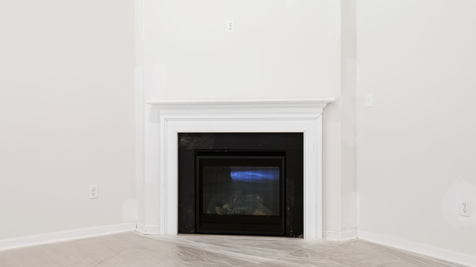 Family room with fireplace and window.