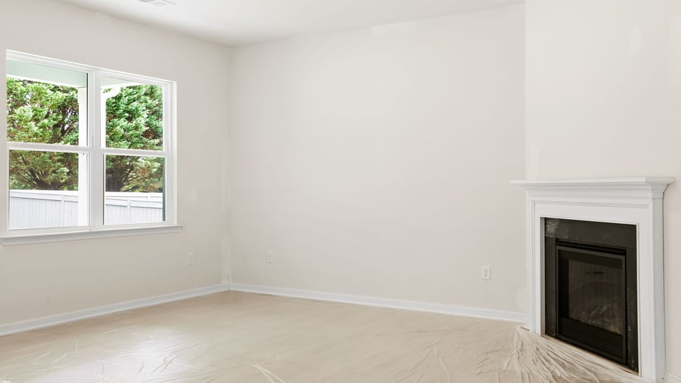 Family room with fireplace and window.