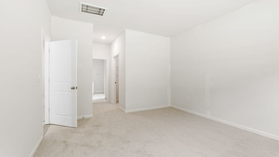Bedroom with carpet and window.