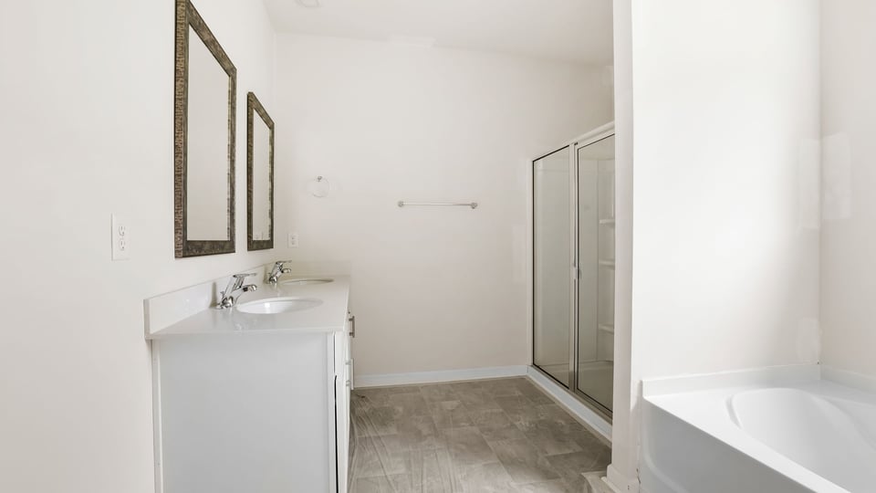 Bathroom with double vanity sink and bathtub.